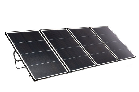 Foldable solar panel with four panels arranged in a sequence, extended and angled to capture sunlight, with a grey Anderson connector.